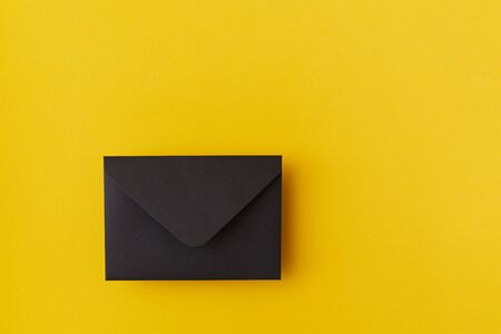 Black envelope on the yellow backgroundの写真素材