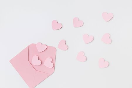 Pink hearts and the pink envelope on the white backgroundの写真素材