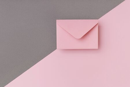 Composition of pink envelope on the pink and grey background