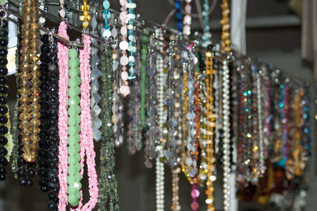 Colorful multi-colored beads and necklaces over the counterの写真素材