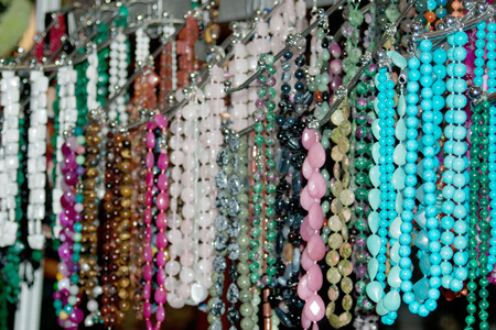 Colorful multi-colored beads and necklaces on the marketの写真素材