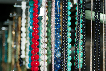 Many colorful Oriental beads and necklaces on the marketの写真素材