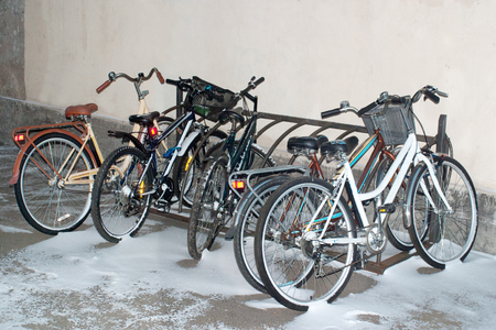 Bikes in the snow on campus. Twilight.の写真素材