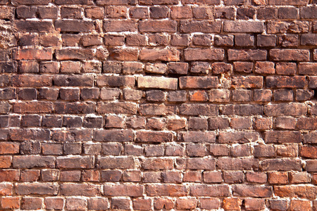 Red and black brick wall with traces of fire.の写真素材