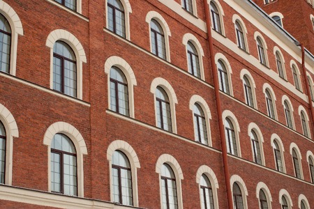 The background is an old brick building with many windowsの写真素材