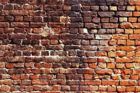 Red and black brick wall with traces of fire and smoke.の写真素材