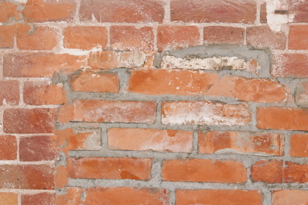 Brick wall with a fragment of the mortgaged window. The cement walls.の写真素材