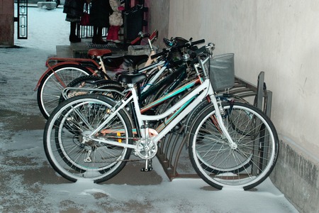 Bikes in the snow on campus. Twilight.の写真素材