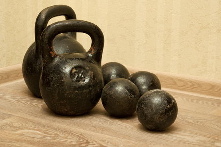 Dumbbells and kettlebells in the gym on the floorの写真素材