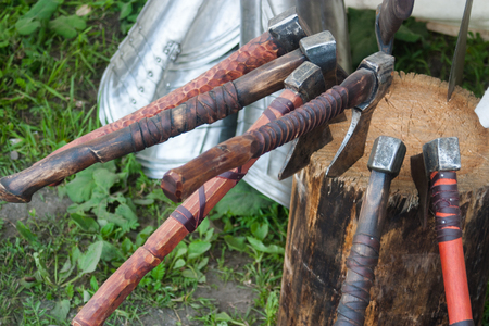 Several old battle axe stuck in the stump. Replica.の写真素材