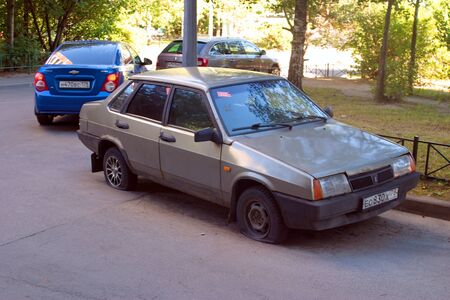Saint Petersburg, Russia - August 08, 2018: Abandoned Soviet vehicle VAZ 21099 run flat tires iのeditorial素材