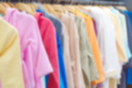 Blurred or defocused image of colored bathrobes on hangersの写真素材