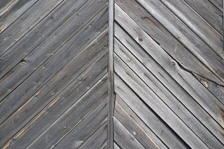 Fragment of the ancient gate of the boards as a background