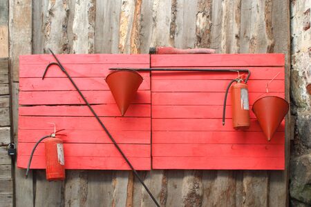 Fire stand with buckets, hooks, fire extinguishers, axeの写真素材