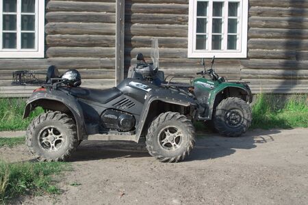 Solovetsky islands, Russia - August 10, 2019: ATVs CFMoto and Yamaha near the wooden houseのeditorial素材