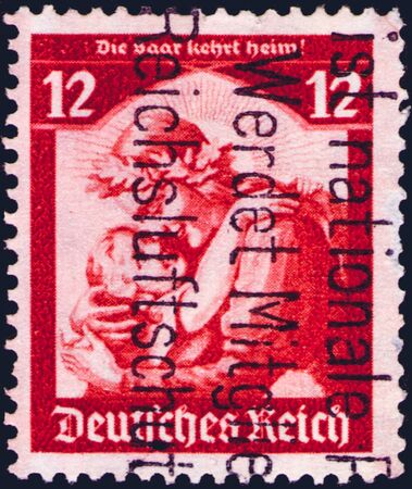 Saint Petersburg, Russia - January 26, 2020: Stamp issued in the Germany dedicated to the inclusion of the Saarland in the Third Reich. From the series on Saar poll, circa 1935のeditorial素材
