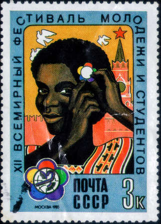 Saint Petersburg, Russia - February 20, 2020: Stamp issued in the Soviet Union with the image of the Girl with festival badge. From the series on 12th World Youth and Students Festival, circa 1985のeditorial素材