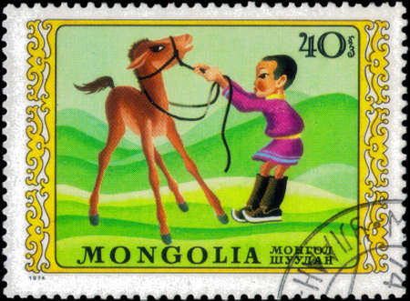 Saint Petersburg, Russia - March 15, 2020: Stamp issued in the Mongolia with the image of the Horse riding. From the series on International Childrens Day, circa 1974のeditorial素材