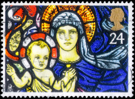 Saint Petersburg, Russia - April 01, 2020: Stamp issued in the United Kingdom with the image of the Madonna and Child, St Mary's, Bibury. From the series on Christmas, Stained-glass Windows, circa 1992のeditorial素材