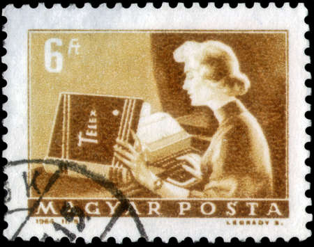 Saint Petersburg, Russia - April 30, 2020: Stamp issued in the Hungary with the image of the Telex operator. From the series on Transport and Telecommunication, circa 1964のeditorial素材