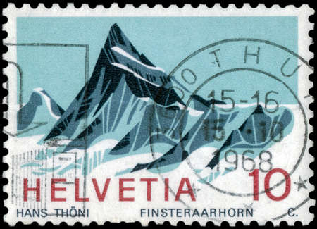 Saint Petersburg, Russia - May 05, 2020: Stamp printed in the Switzerland with the image of the Finsteraarhorn mountain, circa 1966のeditorial素材