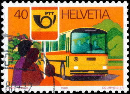 Saint Petersburg, Russia - May 17, 2020: Stamp printed in the Switzerland with the image of the Post omnibus and bus stop, circa 1980のeditorial素材