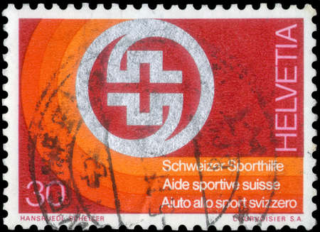 Saint Petersburg, Russia - May 17, 2020: Stamp printed in the Switzerland with the image of the Badge of Swiss Sport Aid, circa 1974のeditorial素材