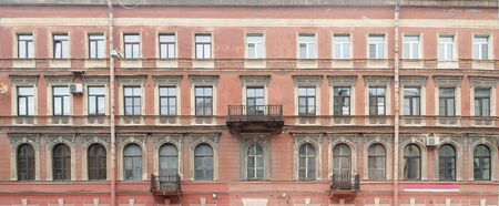 Panorama of the facade of an old apartment building as a backgroundの写真素材