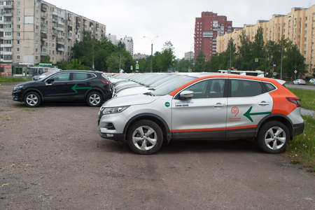 Saint Petersburg, Russia - June 06, 2020: Nissan Qashqai carsharing company YouDrive cars parked in a vacant lot during restrictions due to the epidemic. Side view.のeditorial素材