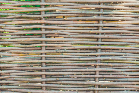 The wall of the hut of woven vine branchesの写真素材