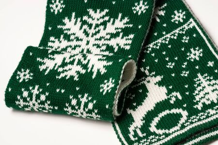 Fragment of green scarf with snowflakes, deer and Christmas tree