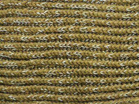 Knitted structure of green threads. Horizontal lines