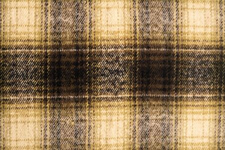 The background is checkered in brown and black in Scottish style.