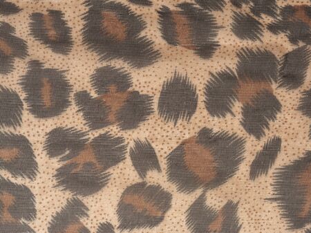 Abstract background in the form of dark brown black spots on light brown background. Like a leopard paint. Close upの写真素材