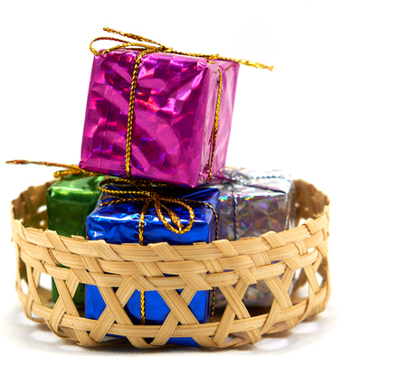 Colorful gift box in a bamboo basketの写真素材