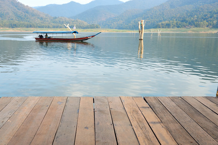 wood board pattern with water boat and mountain in backgroundの写真素材