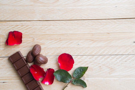 Red rose and chocolate candy on a wooden floor,Valentines Day backgroundの写真素材