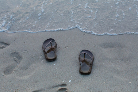 A pair of shoes on the beachの写真素材