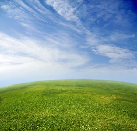 Green grass, blue sky in fish-eye lensの写真素材