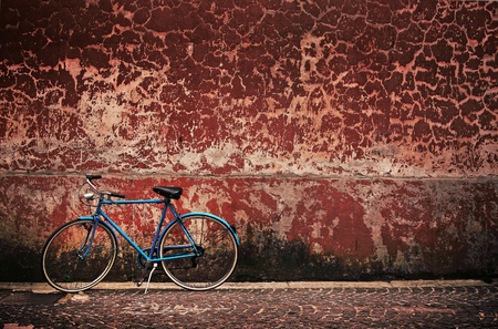 Old retro bicycle over grungy wall の写真素材