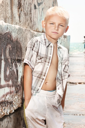 Young boy posing on the beach の写真素材