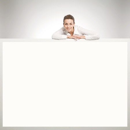 Beautiful businesswoman showing empty white board の写真素材