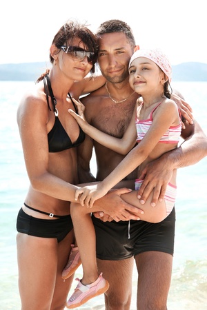 Young family walking on a beach の写真素材