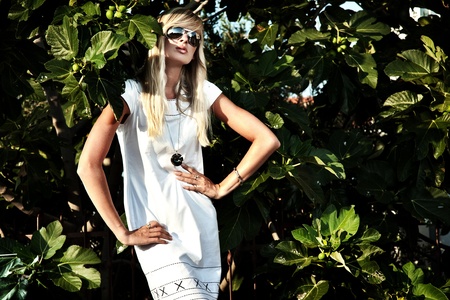 Portrait of the beautiful blond girl in sunglasses の写真素材