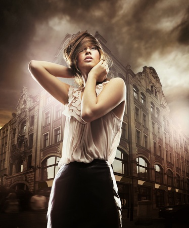Fine art photo of a beautiful woman in front of a buildingの写真素材