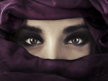 A young middle eastern woman wearing a purple head coveringの写真素材