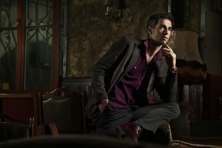 Elegant man posing in a stylish interiorの写真素材