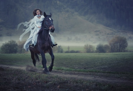 Sensual young beauty riding a horseの写真素材
