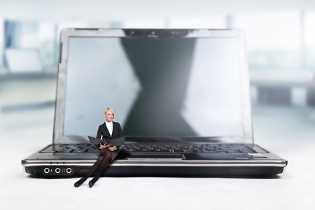 Young businesswoman sitting on a laptopの写真素材