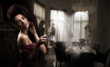 Cute brunette with cup of coffeeの写真素材